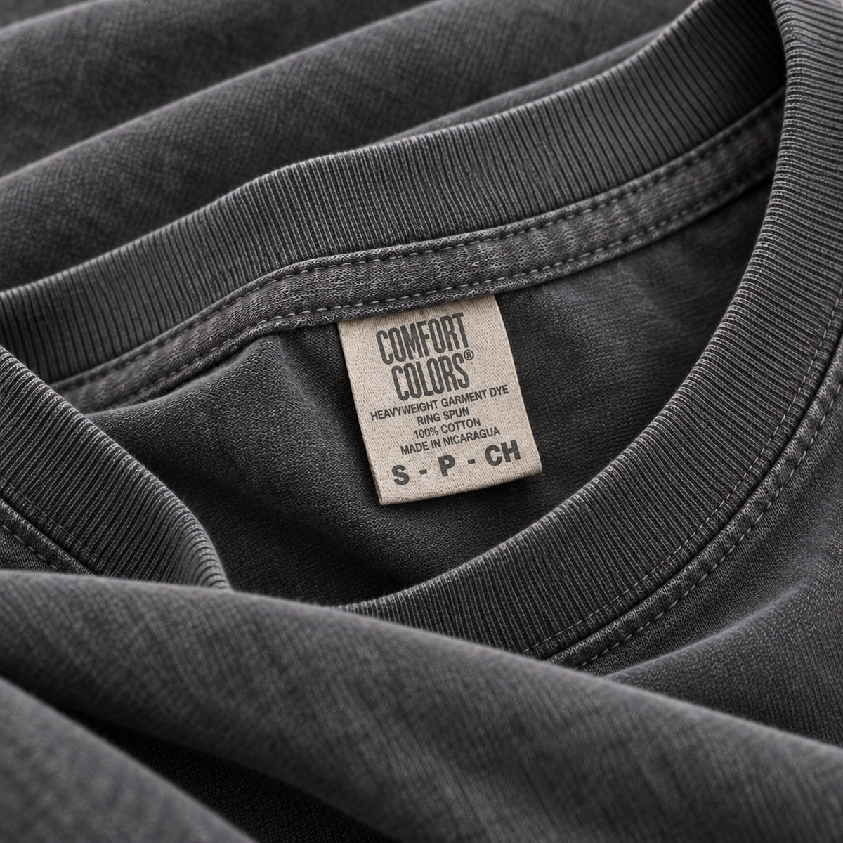 Close-up of a Pepper Comfort Colors 1717 T-shirt neckline, fabric and neck label