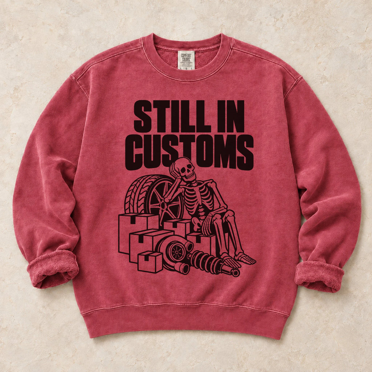 Crimson garment-dyed crewneck sweatshirt with Customs Hold car parts design