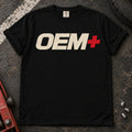 Black car enthusiast T-shirt. OEM+ lettering keeps the factory-plus philosophy simple.