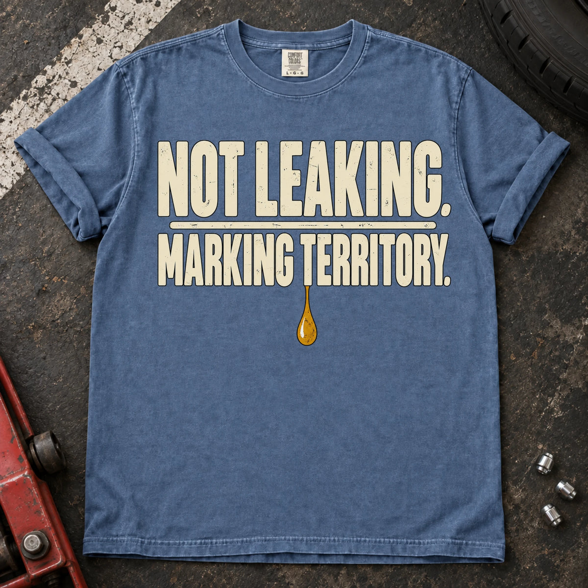 Blue Jean car enthusiast T-shirt. An oil drop backs not leaking, marking territory.