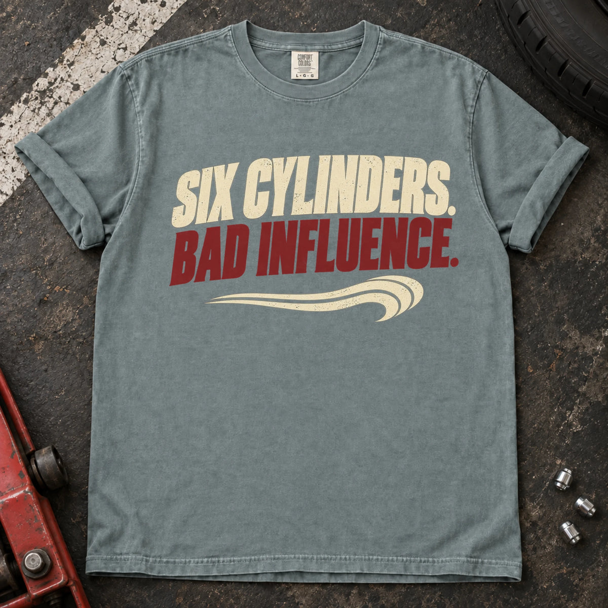 Bay car enthusiast T-shirt. Six cylinders, bad influence, with a sweeping exhaust-style accent.
