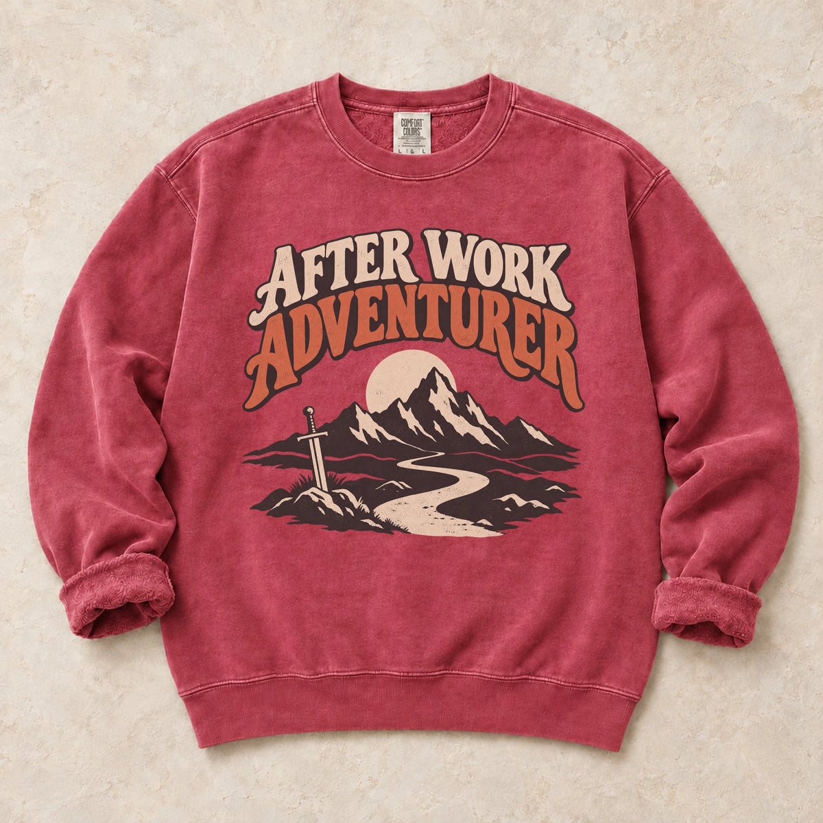 Crimson gaming sweatshirt. An after-work adventurer follows a mountain trail toward a planted sword.