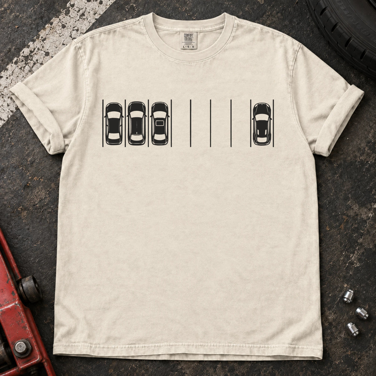 Ivory T-shirt with a minimal overhead parking diagram showing one car parked away from three others.