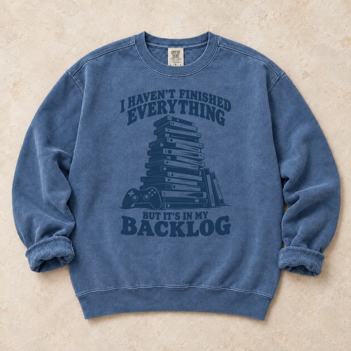 Blue Jean gaming sweatshirt. A game stack admits everything unfinished is in the backlog.