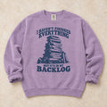 Orchid gaming sweatshirt. A game stack admits everything unfinished is in the backlog.