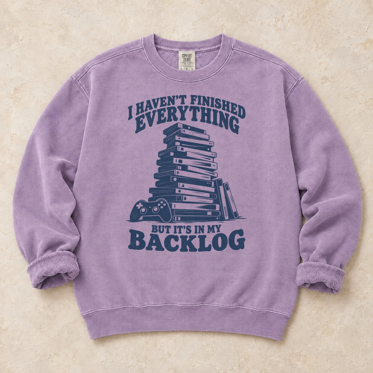 Orchid gaming sweatshirt. A game stack admits everything unfinished is in the backlog.