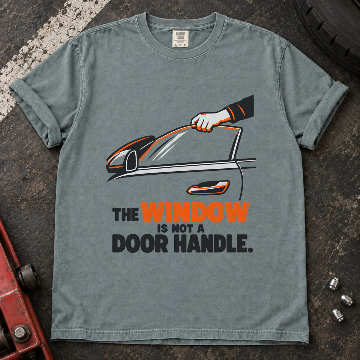 Bay T-shirt showing a hand reaching through a car window with 'The window is not a door handle'.