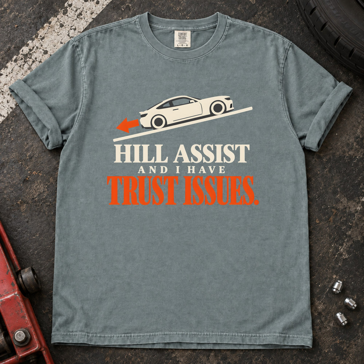 Bay T-shirt showing a car on a slope with 'Hill assist and I have trust issues'.
