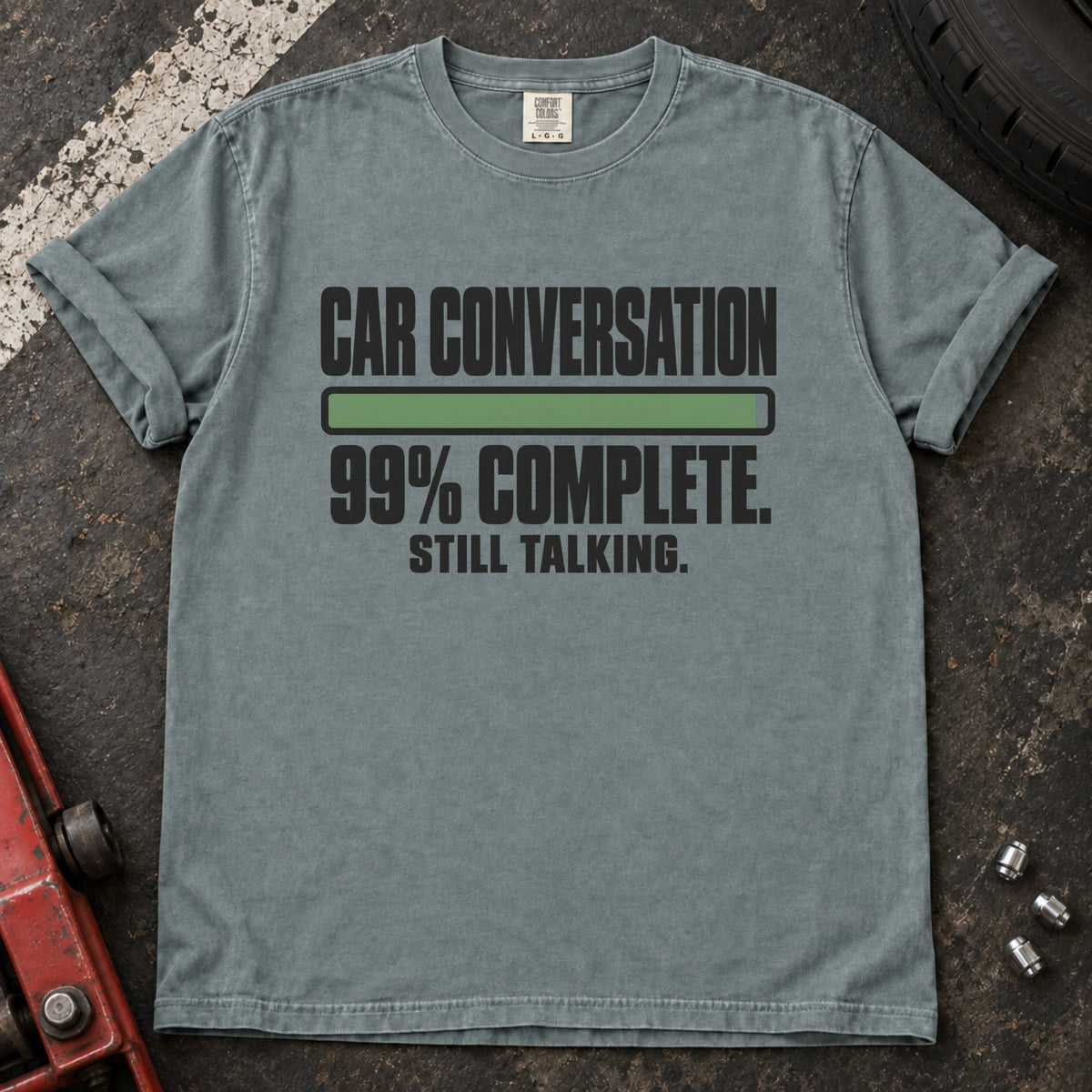 Bay T-shirt showing a nearly full progress bar with 'Car conversation 99% complete. Still talking'.