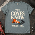 Bay T-shirt showing a fallen orange traffic cone with 'The cones know what I did'.
