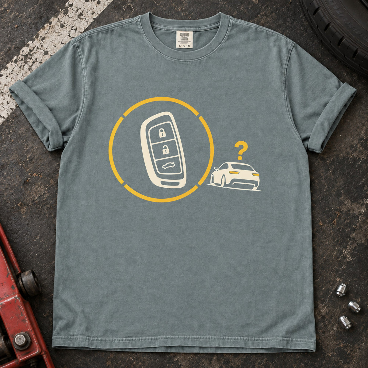 Bay T-shirt with a key fob inside a circular signal graphic beside a small car and question mark.