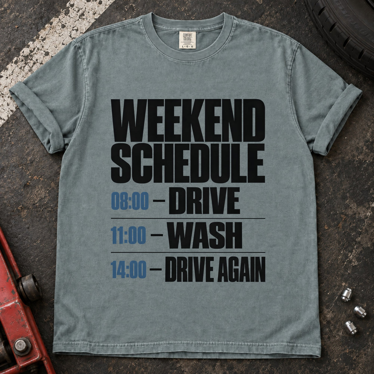 Bay T-shirt listing a weekend schedule: '08:00 Drive, 11:00 Wash, 14:00 Drive again'.