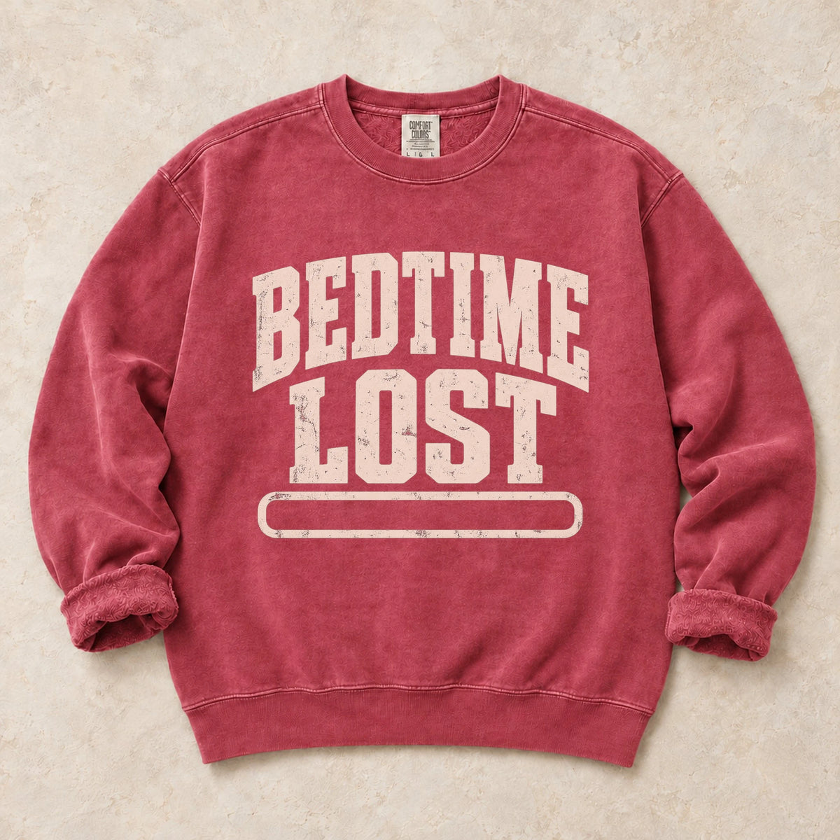 Crimson gaming sweatshirt. A drained progress bar admits bedtime lost.