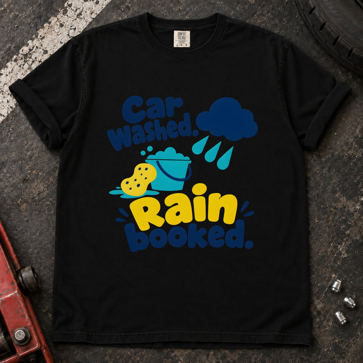 Black T-shirt showing a rain cloud, droplets and cleaning sponge with 'Car washed. Rain booked'.