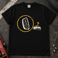 Black T-shirt with a key fob inside a circular signal graphic beside a small car and question mark.