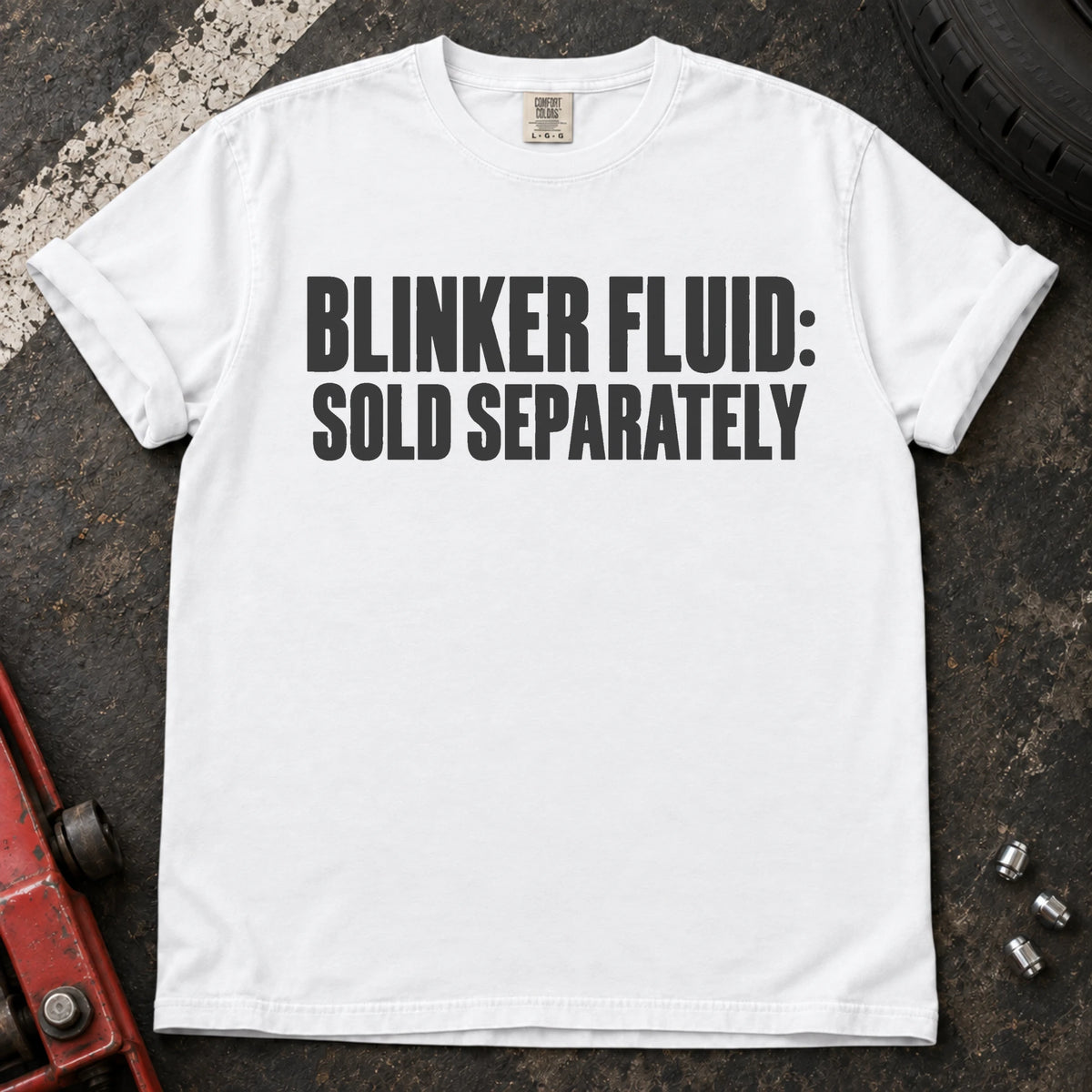 White car enthusiast T-shirt. Blinker fluid sold separately, in dry automotive-humor lettering.