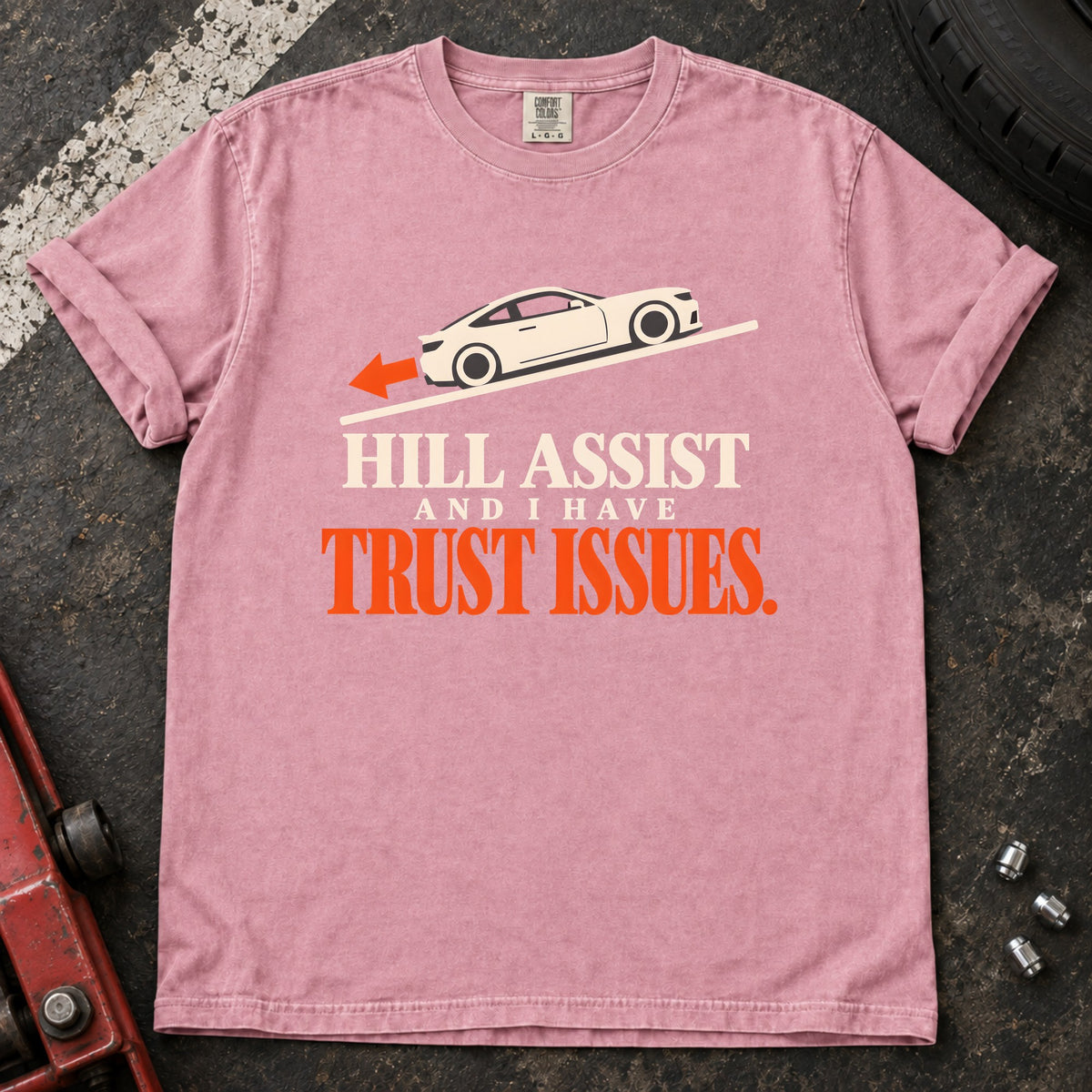 Blossom T-shirt showing a car on a slope with 'Hill assist and I have trust issues'.