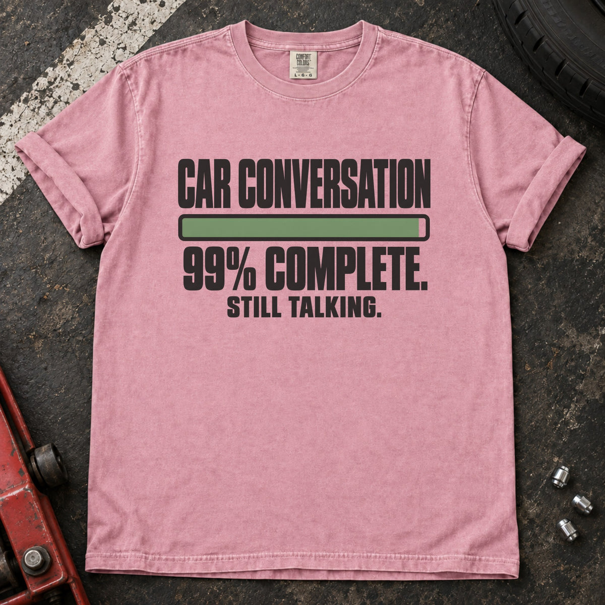 Blossom T-shirt showing a nearly full progress bar with 'Car conversation 99% complete. Still talking'.
