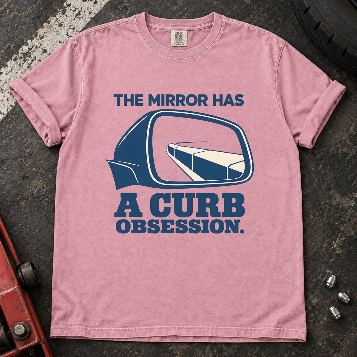 Blossom T-shirt showing a side mirror reflecting a curb with 'The mirror has a curb obsession'.