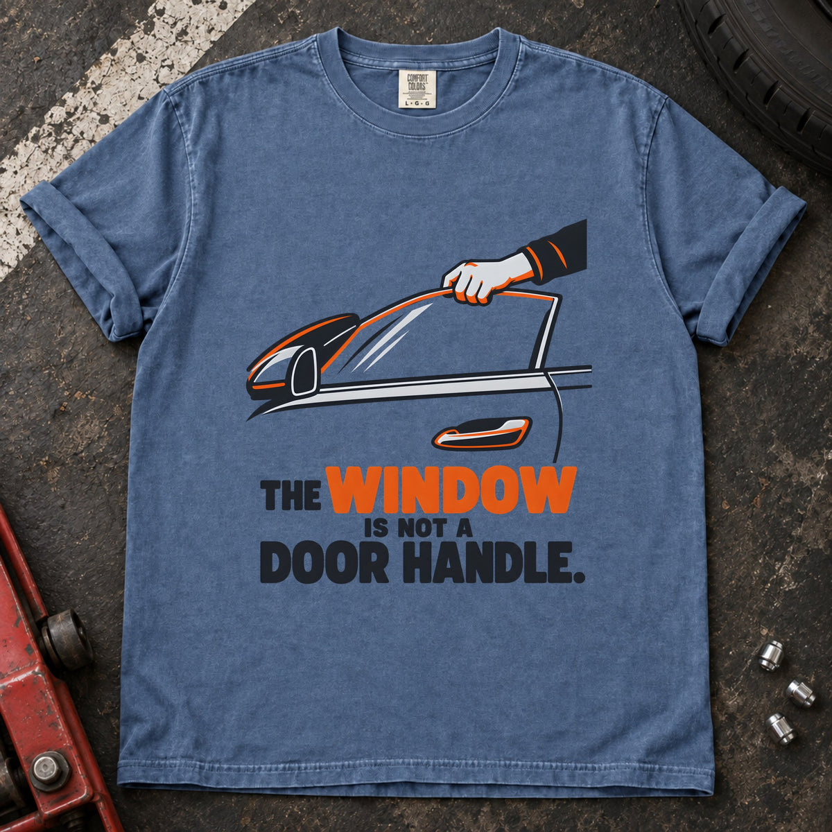 Blue Jean T-shirt showing a hand reaching through a car window with 'The window is not a door handle'.