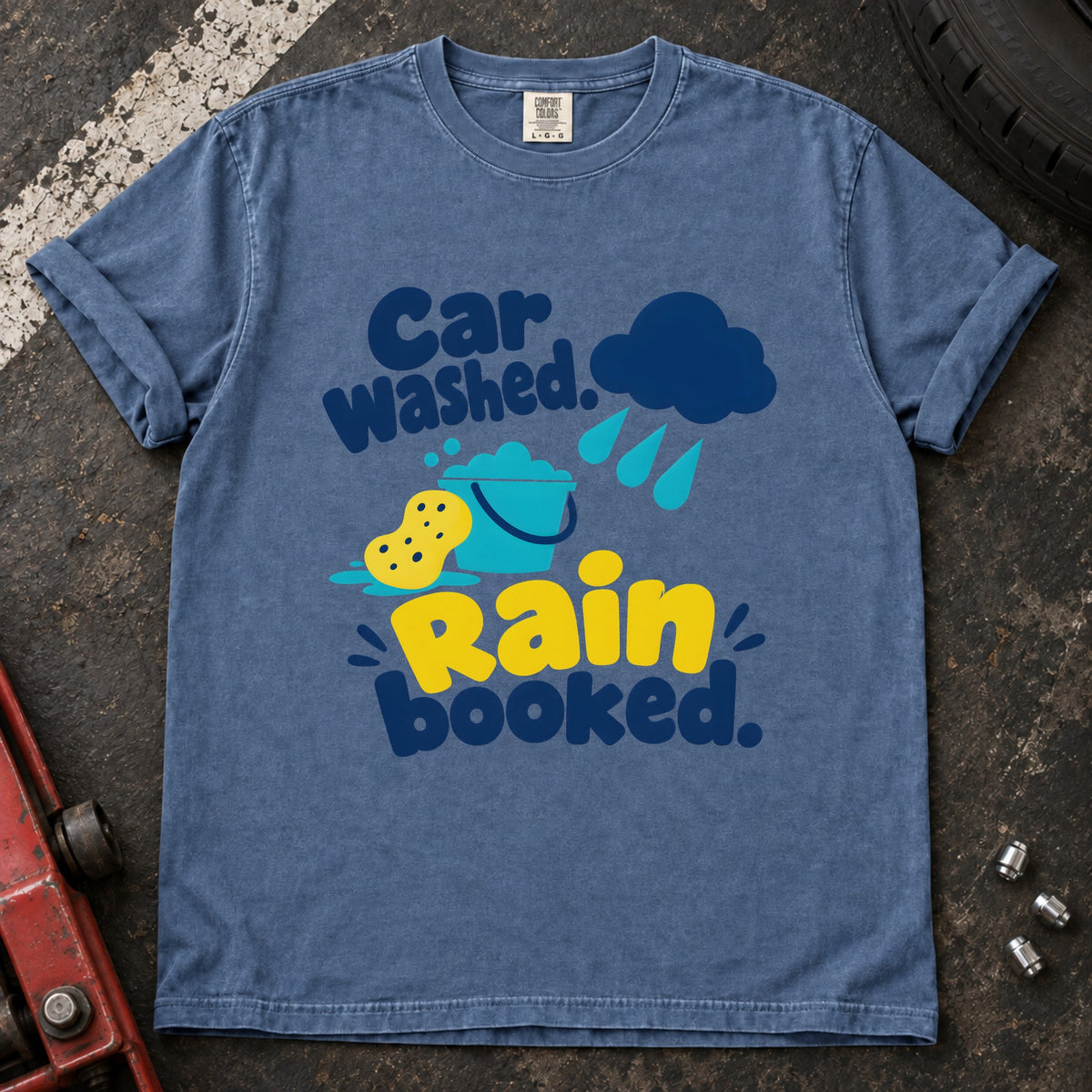 Blue Jean T-shirt showing a rain cloud, droplets and cleaning sponge with 'Car washed. Rain booked'.