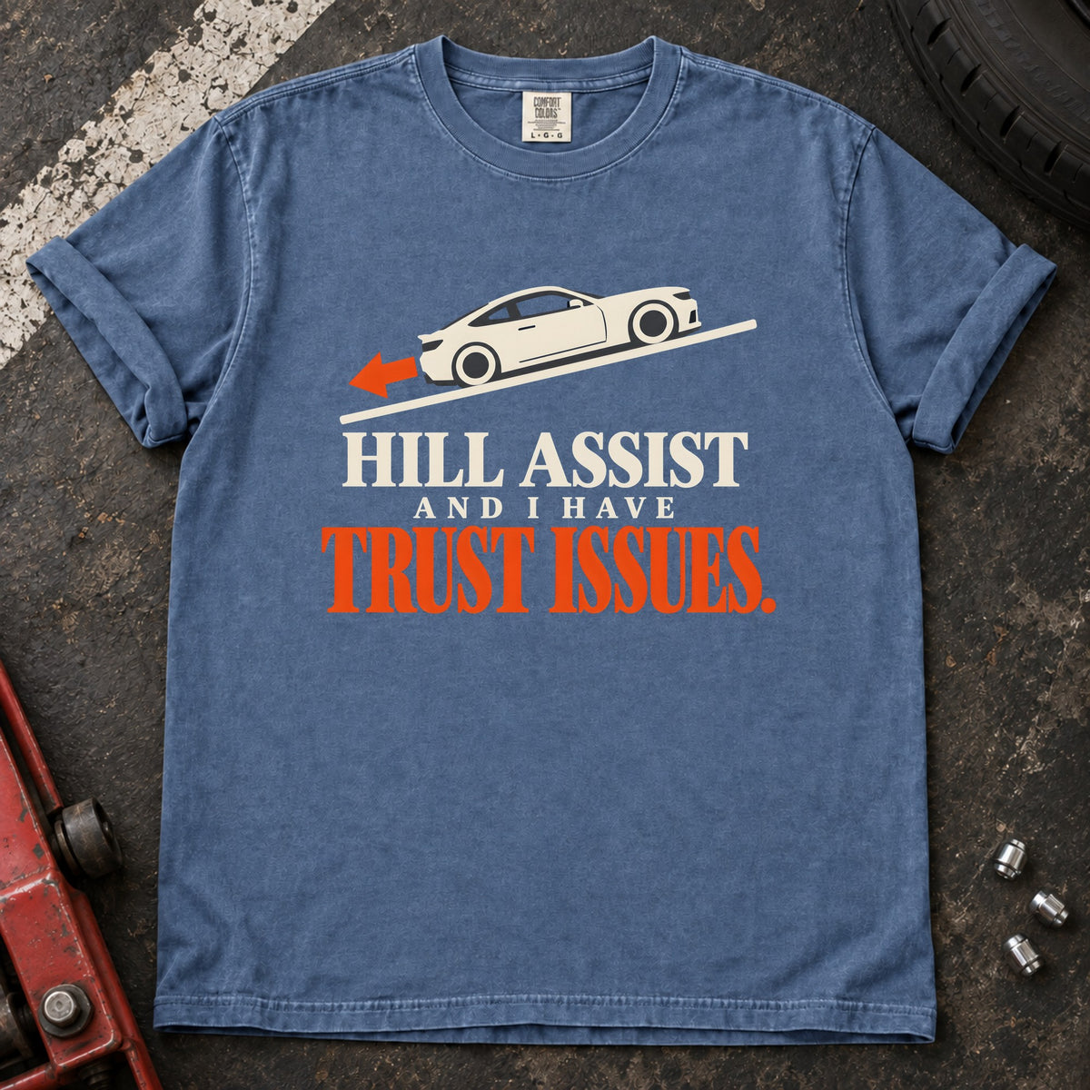 Blue Jean T-shirt showing a car on a slope with 'Hill assist and I have trust issues'.