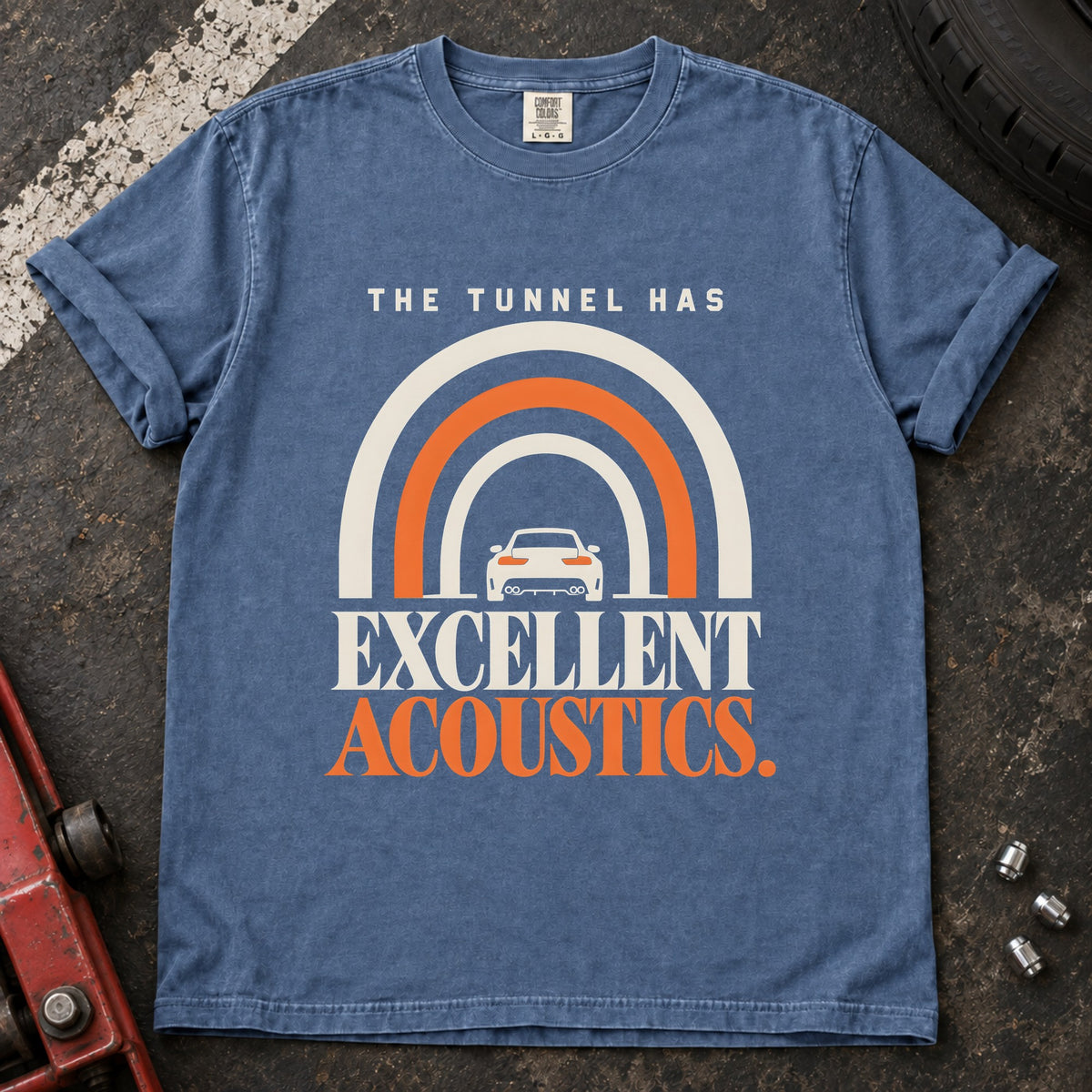 Blue Jean T-shirt showing a car beneath a tunnel-shaped arch with 'The tunnel has excellent acoustics'.