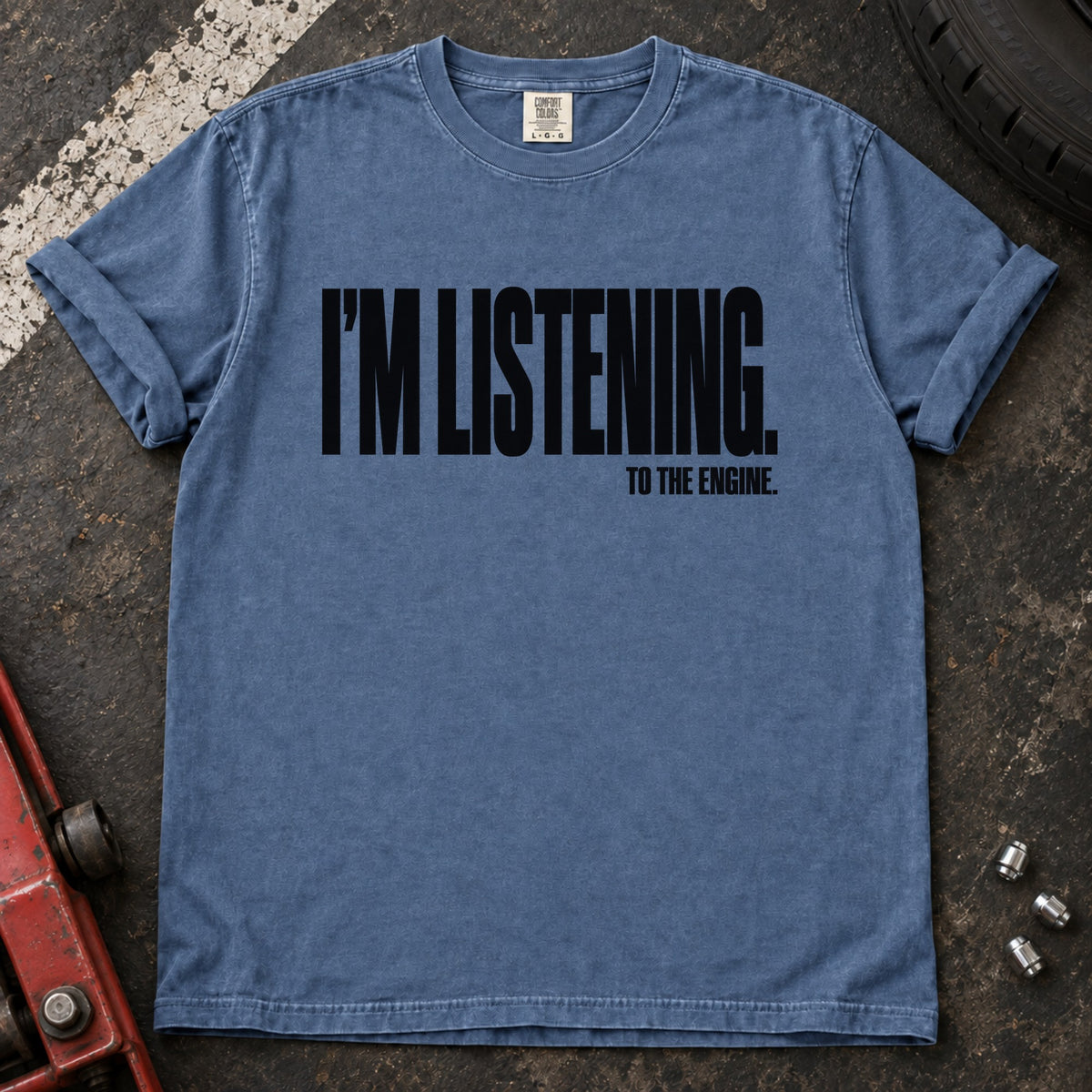 Blue Jean T-shirt with bold condensed lettering reading 'I'm listening to the engine'.