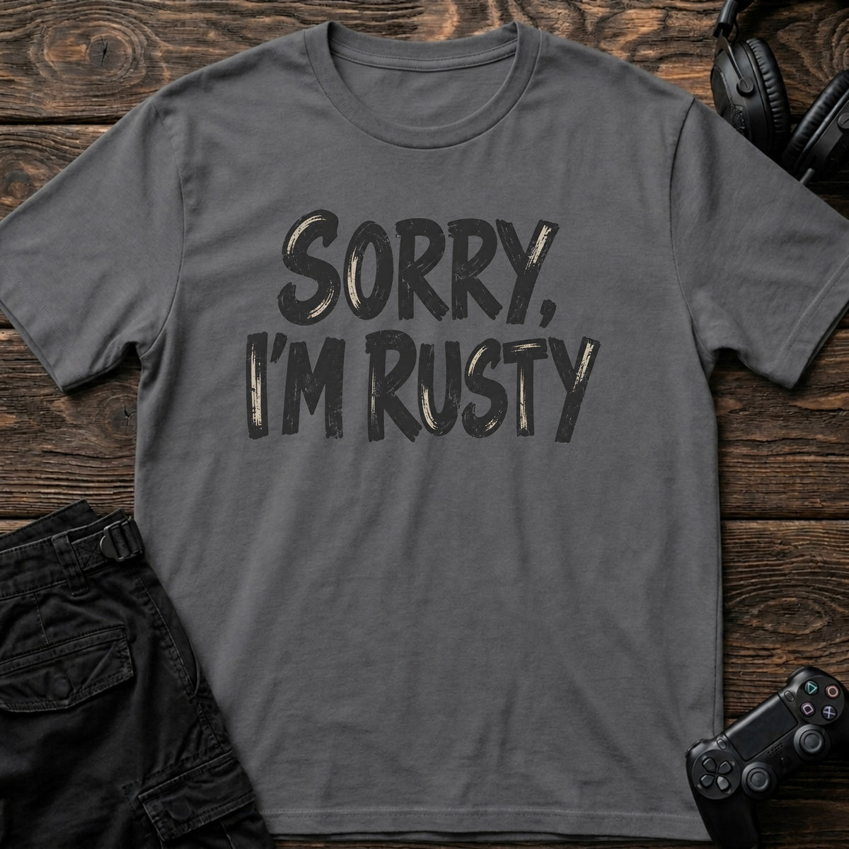 Charcoal gaming T-shirt. Sorry, I'm rusty, in bold brush-style gamer lettering.