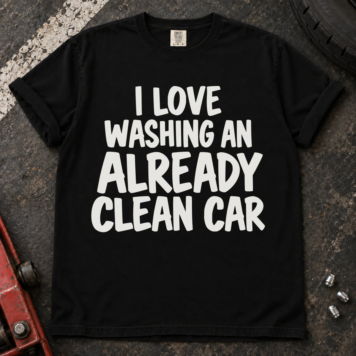 Black T-shirt with bold lettering reading 'I love washing an already clean car'.