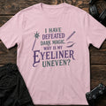 Light Pink gaming T-shirt. A wand and eyeliner joke asks why makeup is harder than dark magic.