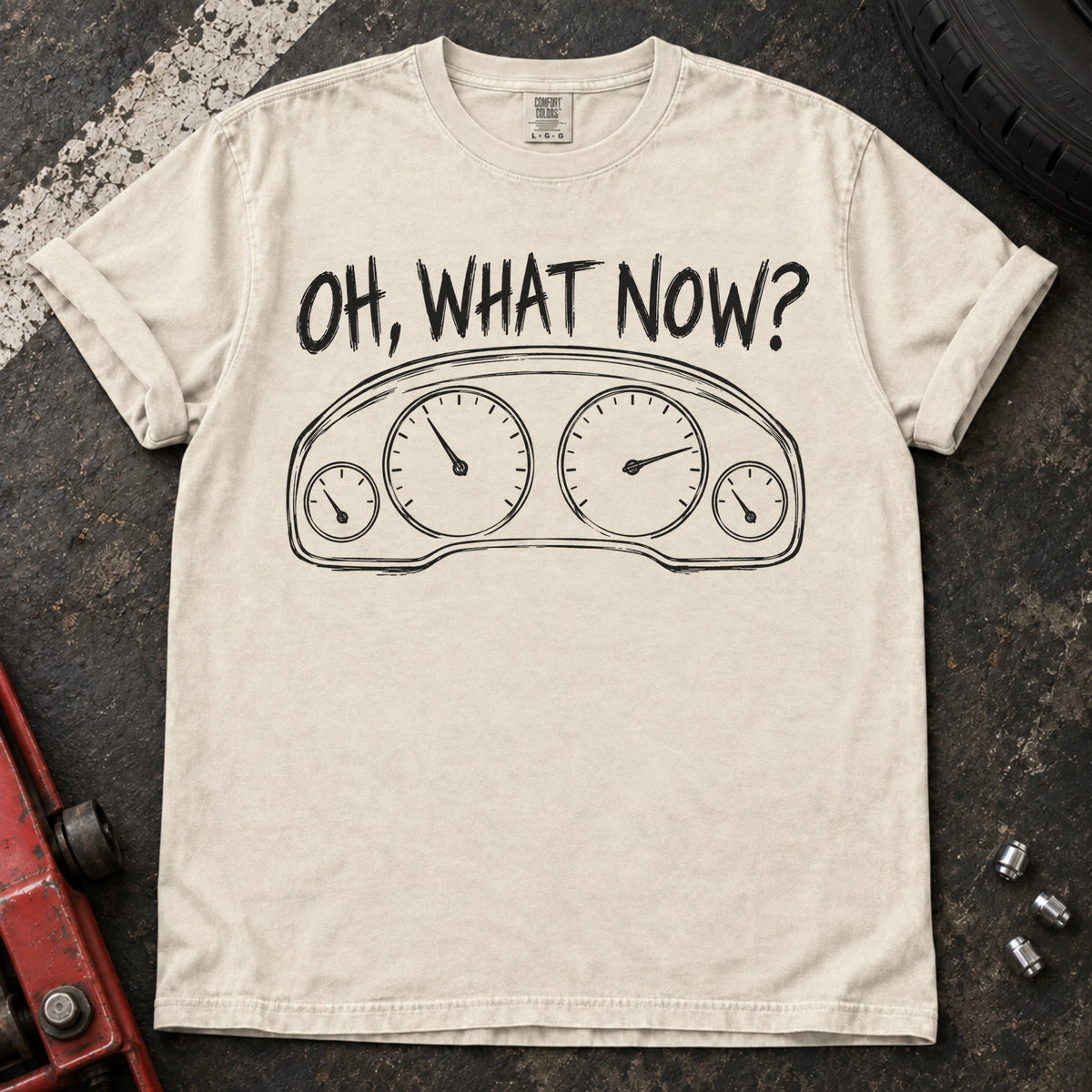 Ivory car enthusiast T-shirt. An instrument cluster meets the familiar car-owner question, oh, what now?
