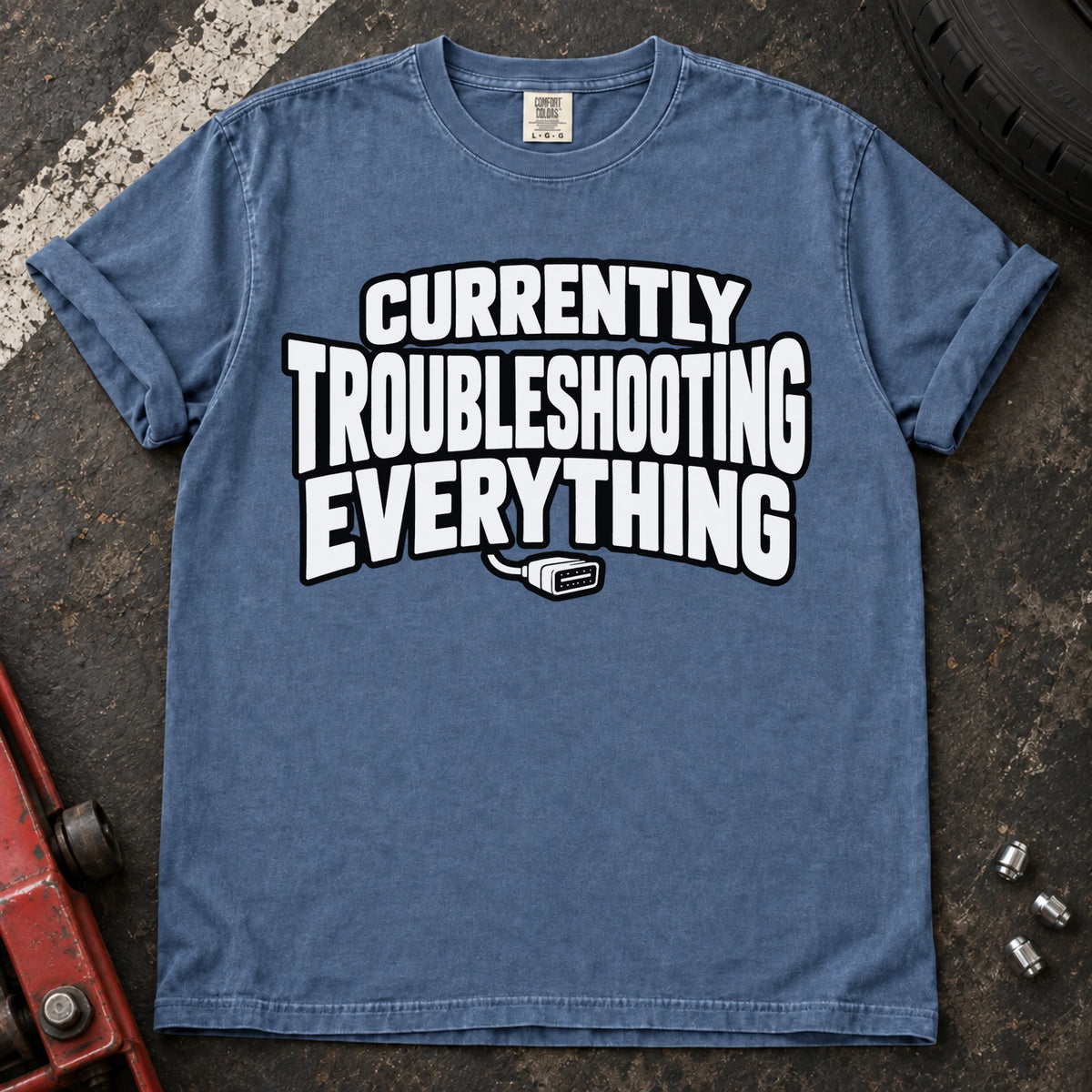 Blue Jean T-shirt reading 'Currently troubleshooting everything' above a small diagnostic connector.