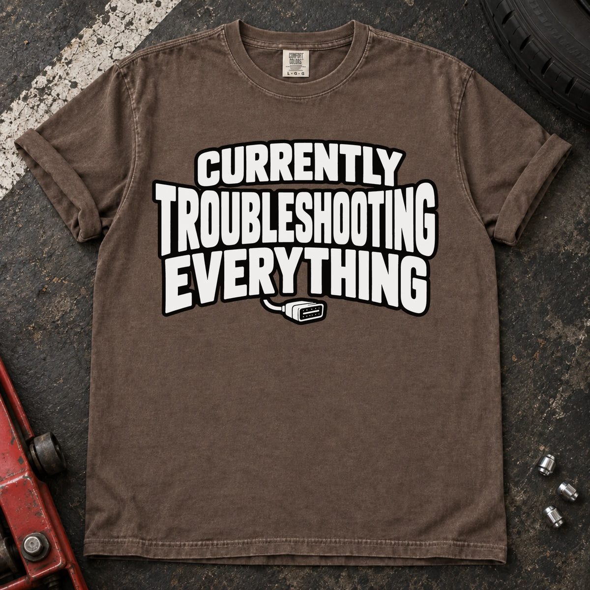 Espresso T-shirt reading 'Currently troubleshooting everything' above a small diagnostic connector.