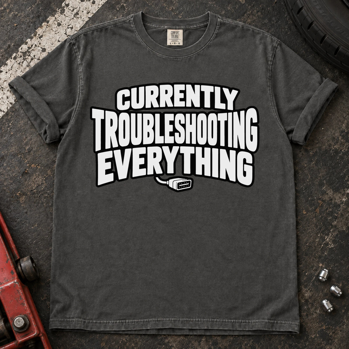 Pepper T-shirt reading 'Currently troubleshooting everything' above a small diagnostic connector.