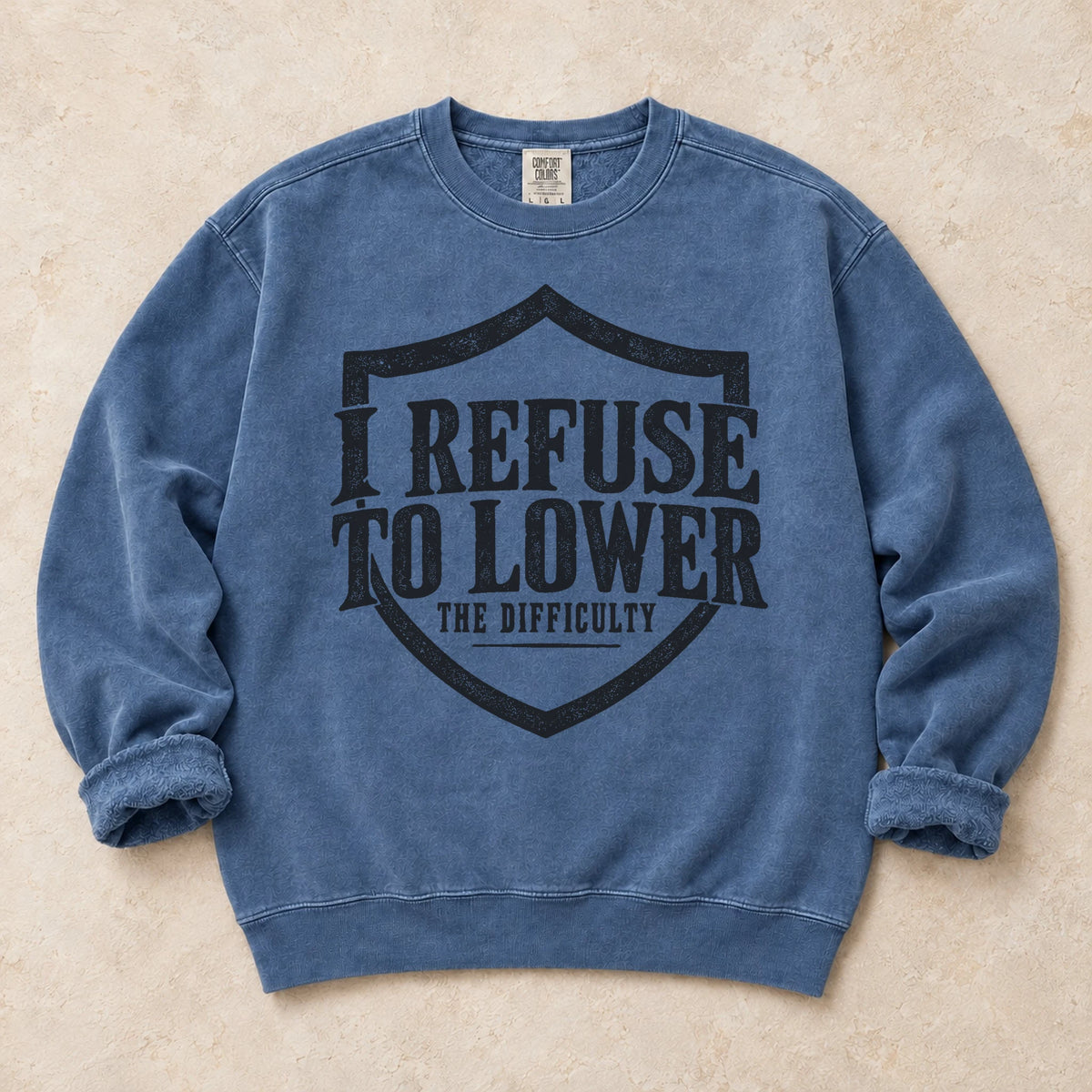 Blue Jean gaming sweatshirt. A shield frames the refusal to lower the difficulty.