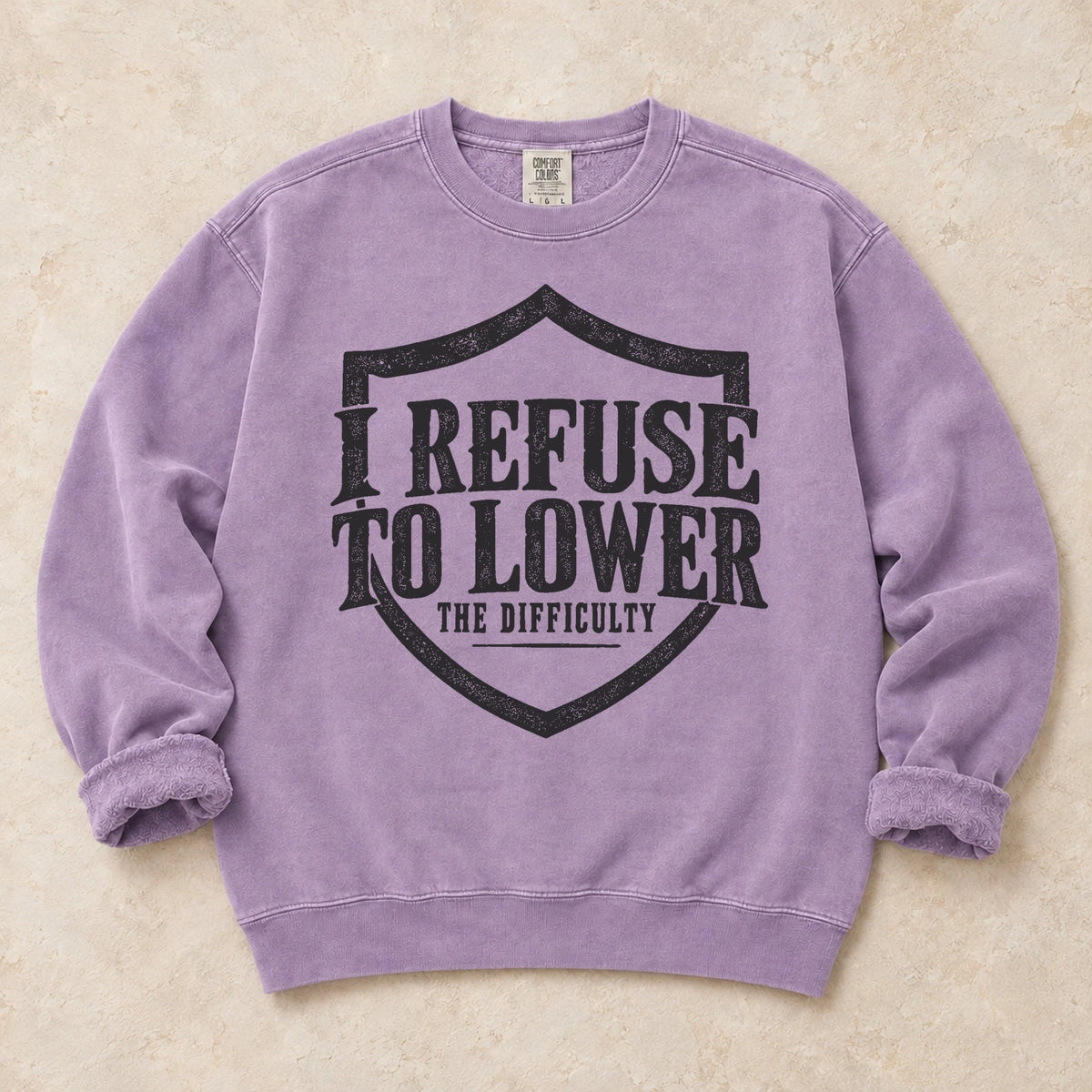Orchid gaming sweatshirt. A shield frames the refusal to lower the difficulty.
