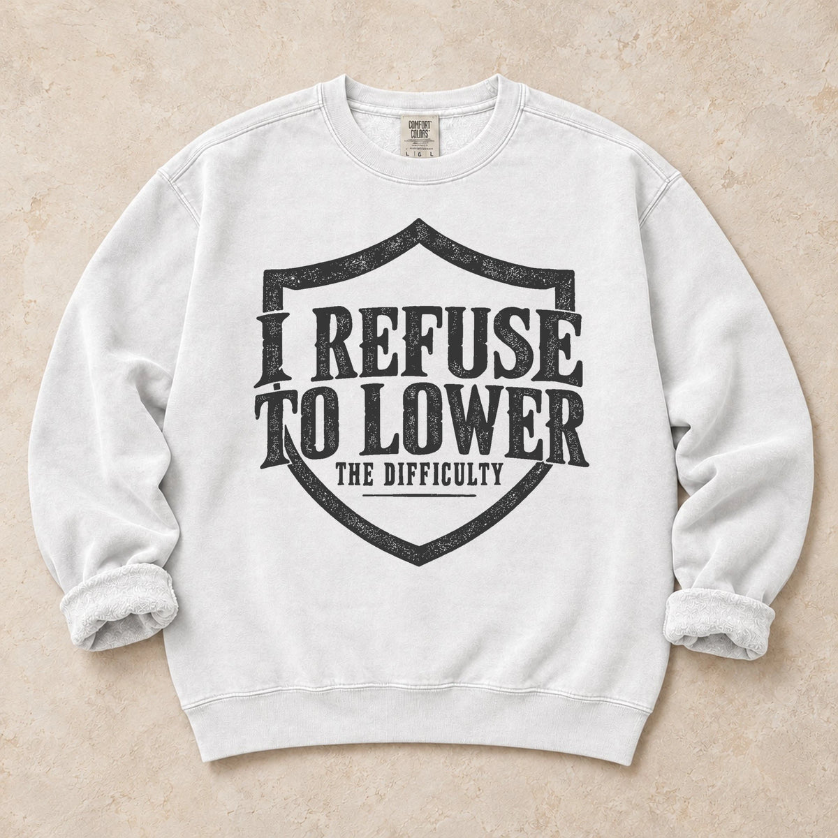 White gaming sweatshirt. A shield frames the refusal to lower the difficulty.