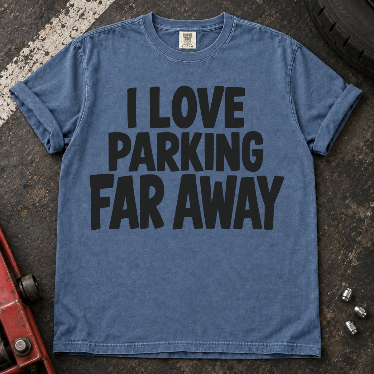 Blue Jean T-shirt with bold stacked lettering reading 'I love parking far away'.