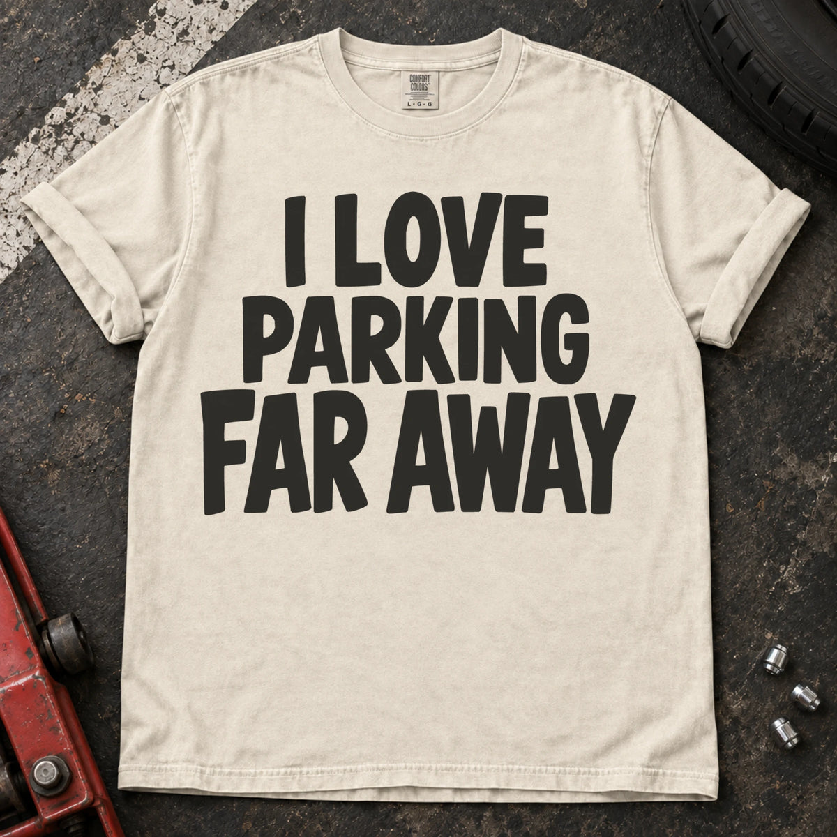 Ivory T-shirt with bold stacked lettering reading 'I love parking far away'.