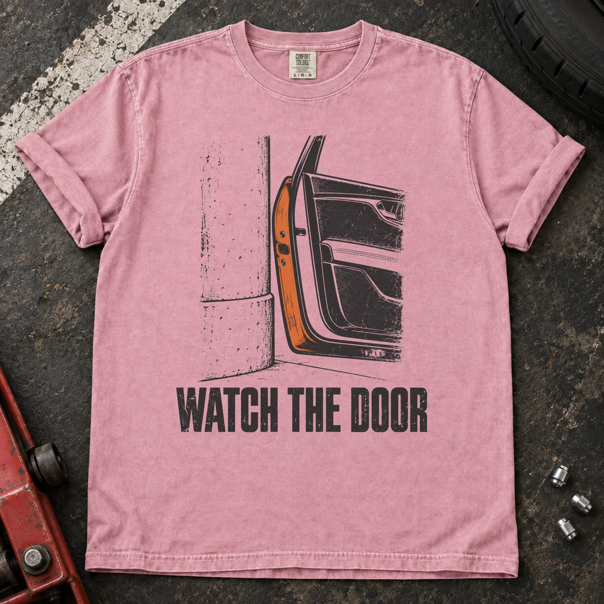 Blossom car enthusiast T-shirt. A car door beside a wall makes watch the door an enthusiast's warning.