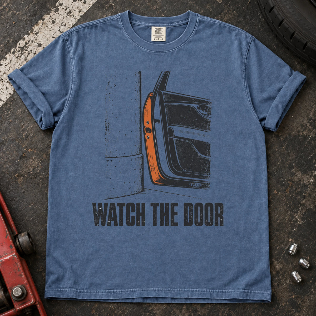 Blue Jean car enthusiast T-shirt. A car door beside a wall makes watch the door an enthusiast's warning.