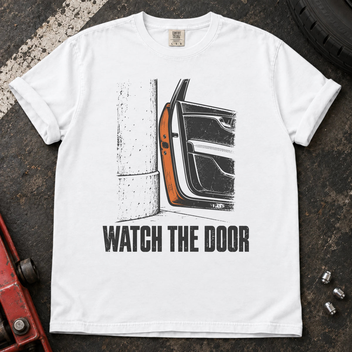 White car enthusiast T-shirt. A car door beside a wall makes watch the door an enthusiast's warning.