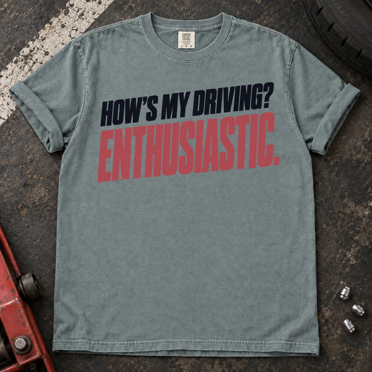Bay car enthusiast T-shirt. How's my driving? Enthusiastic. Bold lettering for the self-aware car lover.