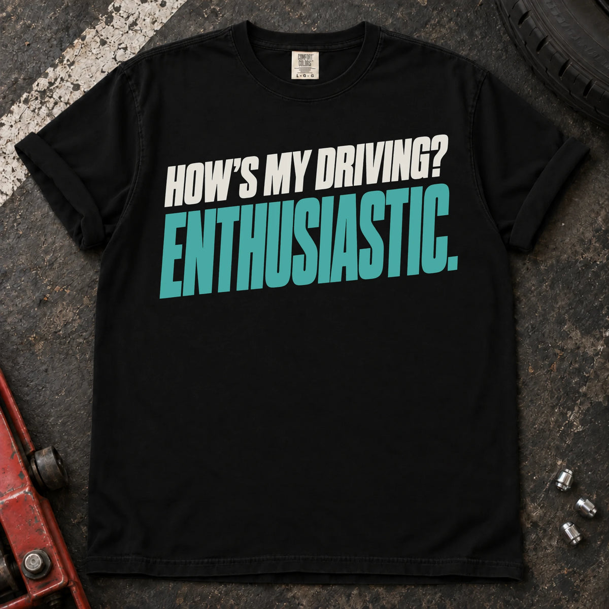 Black car enthusiast T-shirt. How's my driving? Enthusiastic. Bold lettering for the self-aware car lover.