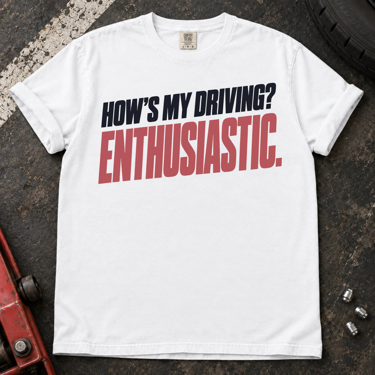 White car enthusiast T-shirt. How's my driving? Enthusiastic. Bold lettering for the self-aware car lover.
