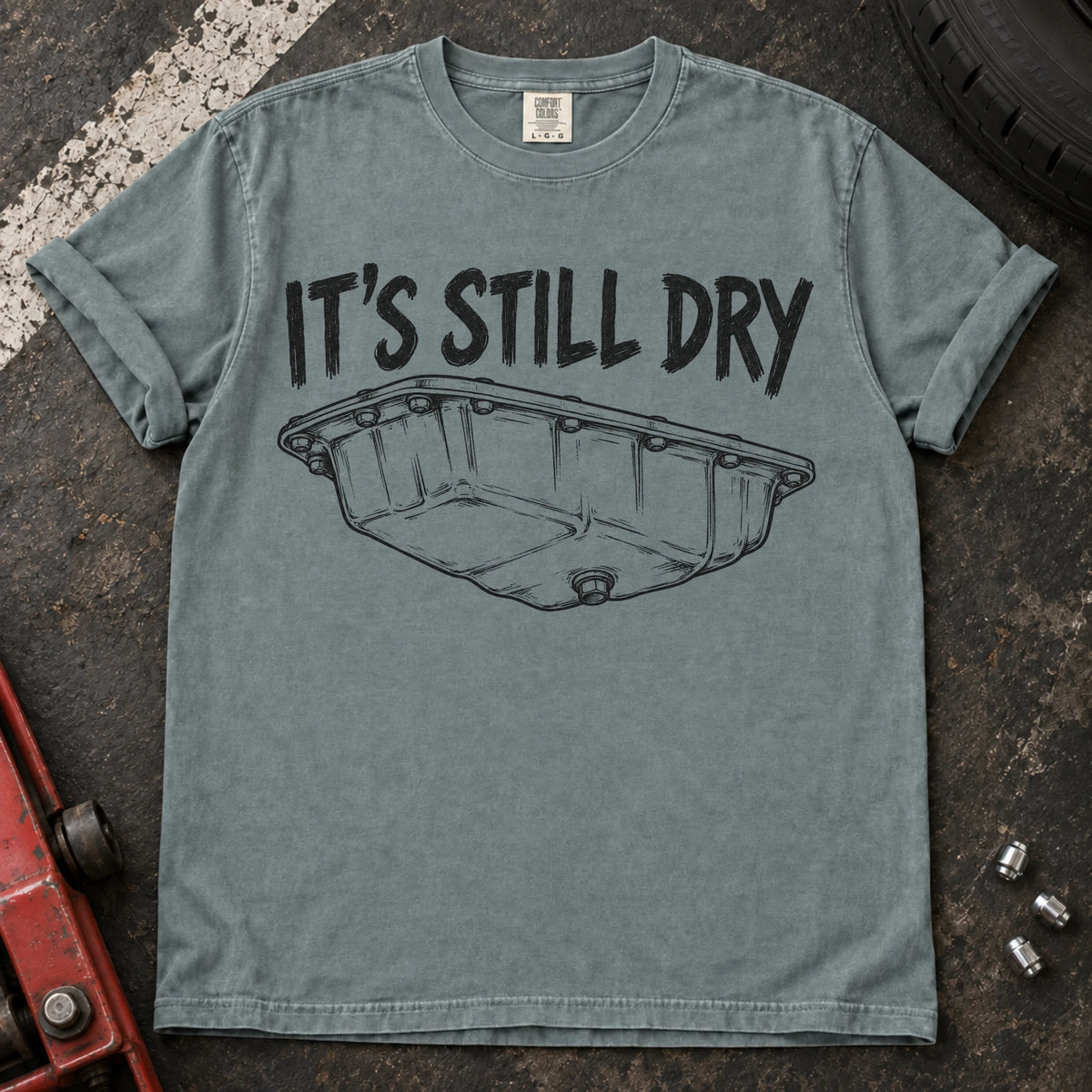 Bay car enthusiast T-shirt. An oil-pan illustration makes it's still dry a cautious automotive joke.