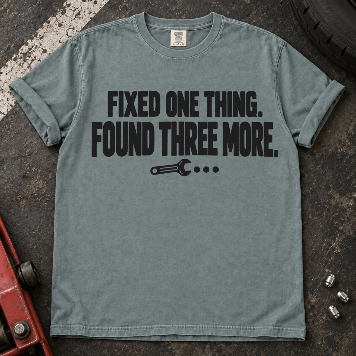 Bay T-shirt reading 'Fixed one thing. Found three more' above a small wrench.