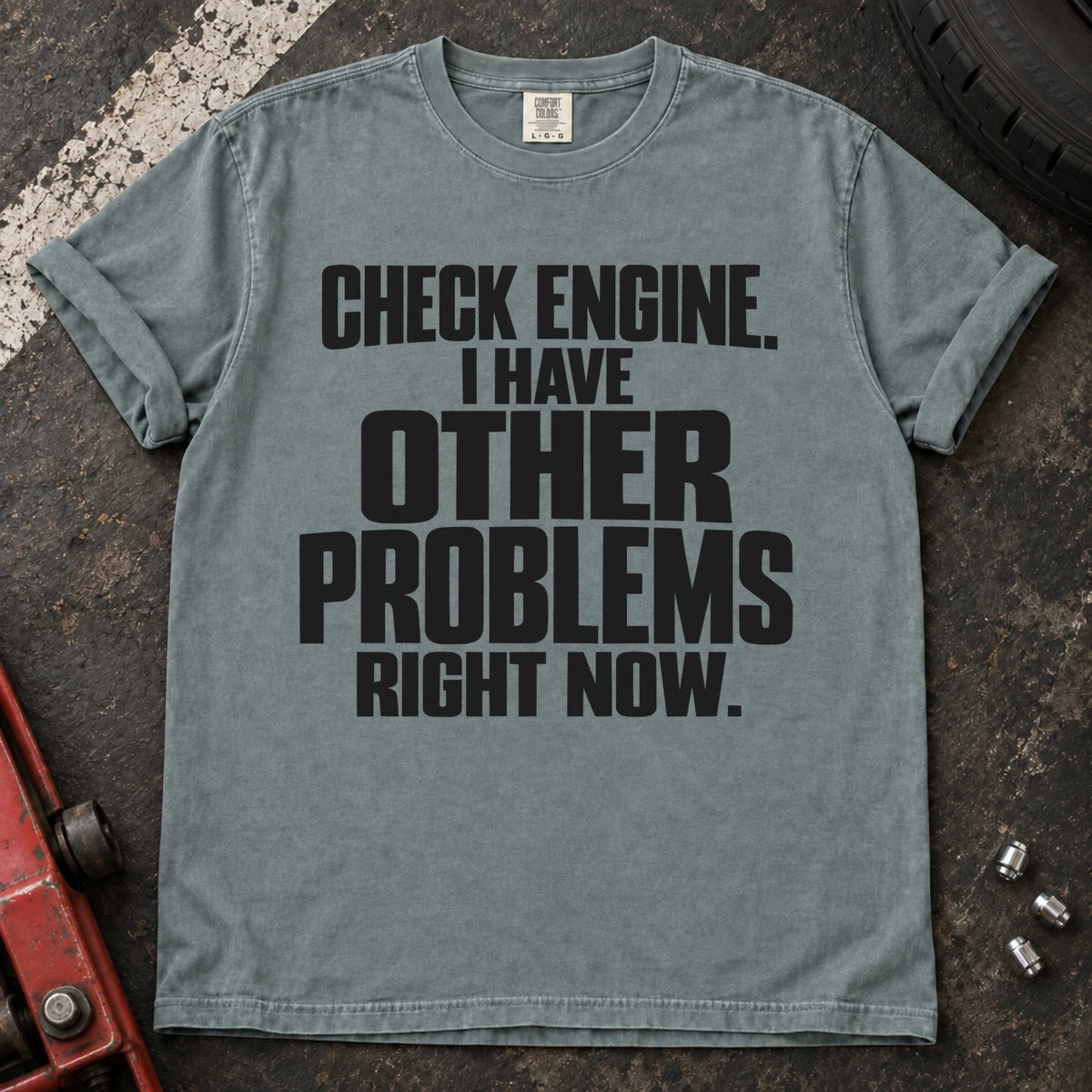Bay T-shirt reading 'Check engine. I have other problems right now' in stacked lettering.