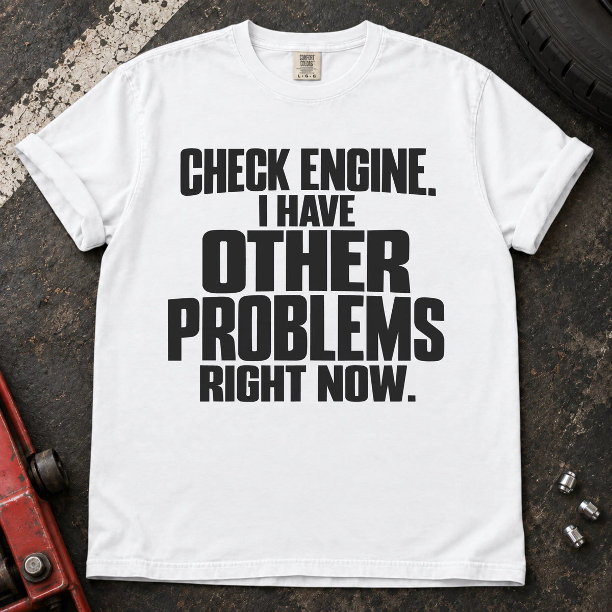 White T-shirt reading 'Check engine. I have other problems right now' in stacked lettering.